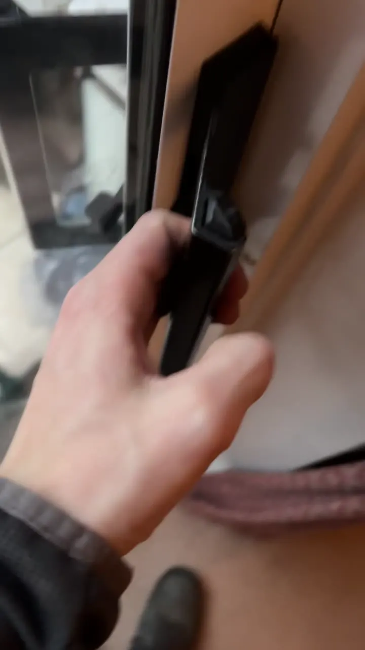 Close-up of a sliding patio door handle being repaired